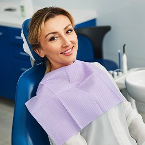 Woman smiling while sitting in treatment chair
