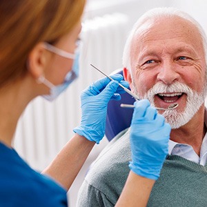 Man smiles at dentist