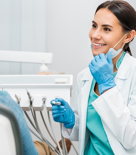 Dentist smiling at patient in treatment chair