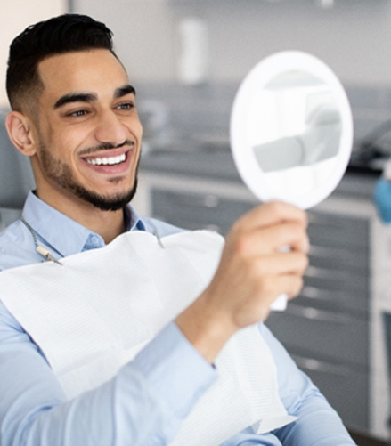 A handsome man admiring his new smile