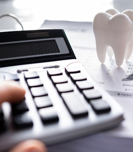 A patient calculating the cost of their dental care