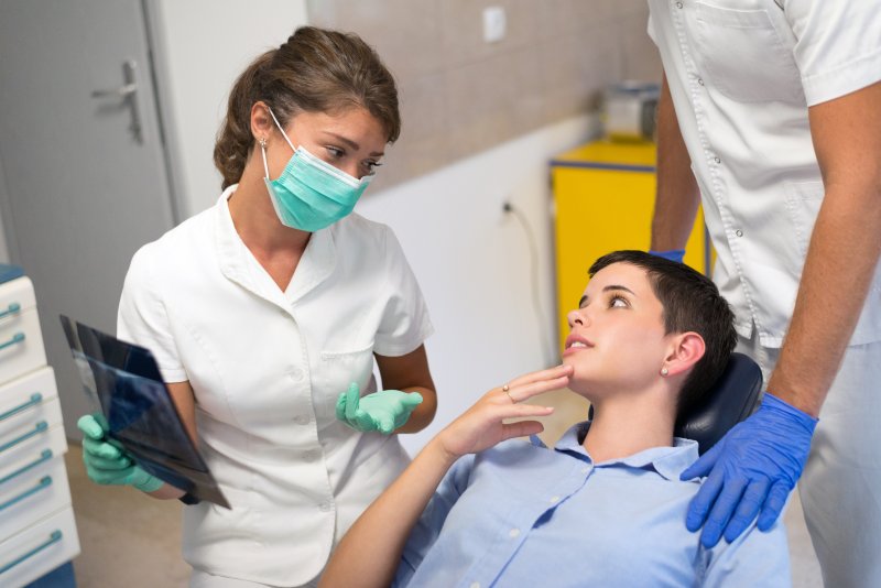 Dentist talking to patient about oral bacteria