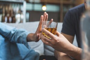 Person turning down alcohol.